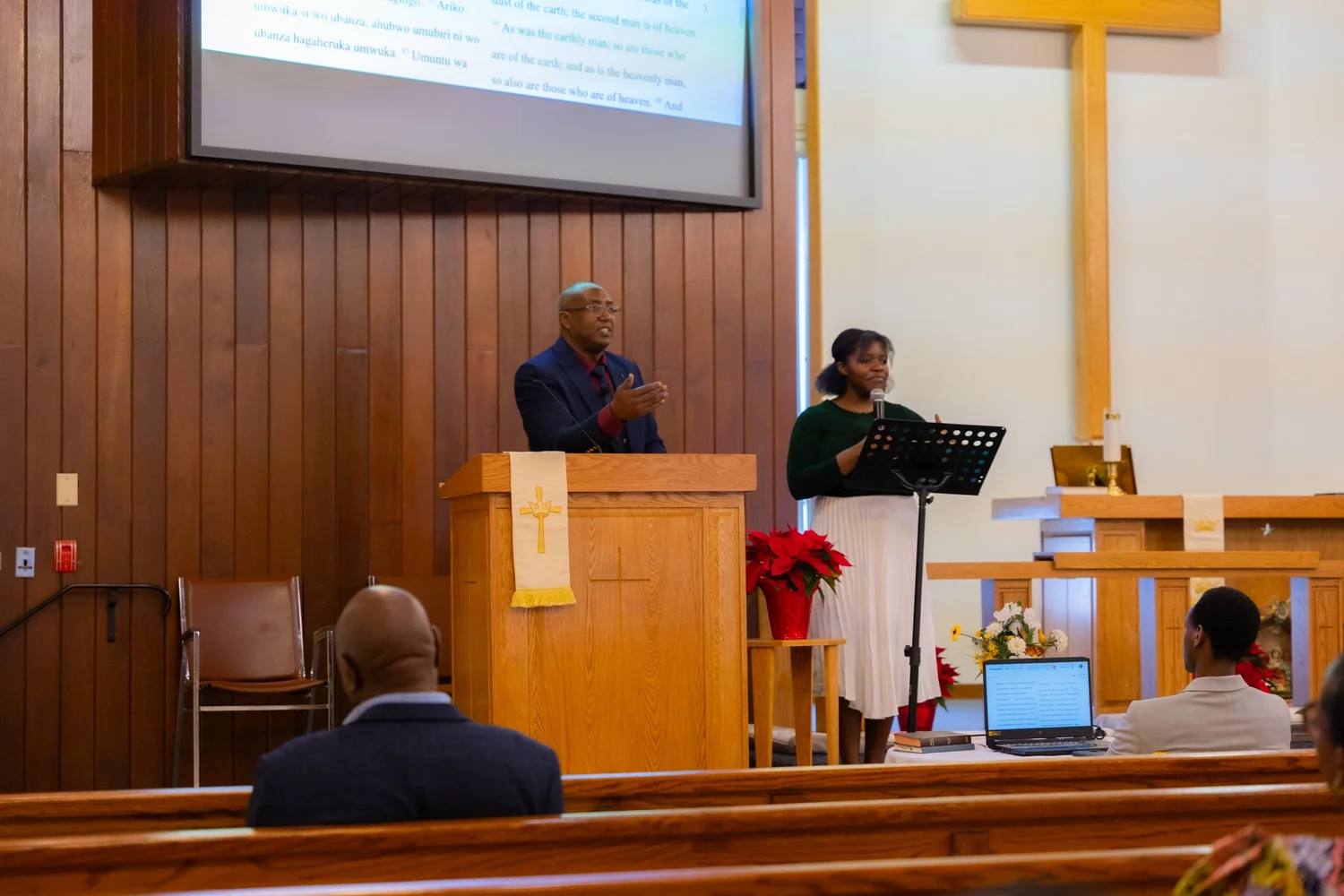 A Friday night prayer gathering with a speaker, musician, and sanctuary cross